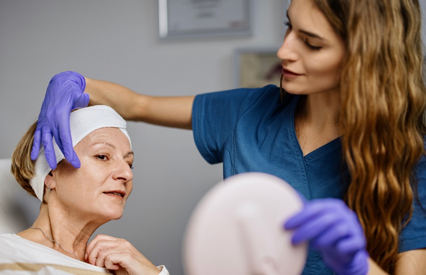 Young female doctor discusses beauty treatments with mature woman patient